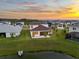 Aerial view of the home showing the screened lanai, backyard, and water view at 8612 Ivy Stark Blvd, Wesley Chapel, FL 33545