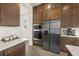 A kitchen with stainless steel appliances and modern fixtures provides ample counter space at 8612 Ivy Stark Blvd, Wesley Chapel, FL 33545