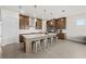 Modern kitchen featuring a large island with seating, stainless steel appliances, and ample cabinet space at 8612 Ivy Stark Blvd, Wesley Chapel, FL 33545