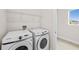 Laundry room featuring side-by-side Samsung washer and dryer at 8612 Ivy Stark Blvd, Wesley Chapel, FL 33545