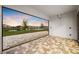 Covered patio with a brick floor and a view of the pond at 8612 Ivy Stark Blvd, Wesley Chapel, FL 33545