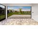 Covered patio with decorative stone, view of the pond, and neighboring homes at 8612 Ivy Stark Blvd, Wesley Chapel, FL 33545