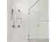 Contemporary walk-in shower with white tile surround, dual shower heads and glass door at 8612 Ivy Stark Blvd, Wesley Chapel, FL 33545