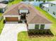 Lovely home with a brown roof, manicured lawn, and a beautiful cobblestone driveway at 8749 Drummer Plank Dr, Wesley Chapel, FL 33545