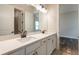 Bathroom with dual sinks, quartz countertop, and modern fixtures provides a functional and stylish space at 8749 Drummer Plank Dr, Wesley Chapel, FL 33545