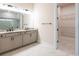 A Primary bathroom featuring a double vanity with granite countertops and a walk in closet at 8749 Drummer Plank Dr, Wesley Chapel, FL 33545