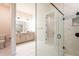 A Primary bathroom featuring a double vanity and a large seamless glass shower with marble tile at 8749 Drummer Plank Dr, Wesley Chapel, FL 33545