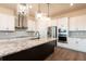 Modern kitchen with granite counters, stainless appliances, pendant lighting, and custom backsplash at 8749 Drummer Plank Dr, Wesley Chapel, FL 33545
