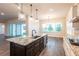 The kitchen features a large island, modern appliances, and seamless access to the outdoor patio through sliding glass doors at 8749 Drummer Plank Dr, Wesley Chapel, FL 33545