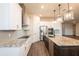 A modern kitchen featuring stainless appliances, granite counters, a central island, and tile backsplash, great for cooking at 8749 Drummer Plank Dr, Wesley Chapel, FL 33545