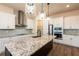A gourmet kitchen features granite countertops, stainless appliances, and a stylish tile backsplash for modern appeal at 8749 Drummer Plank Dr, Wesley Chapel, FL 33545