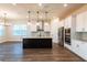 Bright kitchen features a large island, stainless steel appliances, and ample counter space, perfect for cooking and entertaining at 8749 Drummer Plank Dr, Wesley Chapel, FL 33545