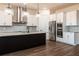 Modern kitchen boasts a large center island, granite countertops, stainless steel appliances, and pendant lighting at 8749 Drummer Plank Dr, Wesley Chapel, FL 33545