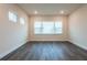 A bright, minimalist living room with large windows providing ample natural light and creating an open, airy feel at 8749 Drummer Plank Dr, Wesley Chapel, FL 33545