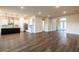 Spacious living room with modern finishes seamlessly connects to kitchen and front entrance at 8749 Drummer Plank Dr, Wesley Chapel, FL 33545