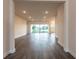 Inviting living room with hardwood floors and large sliding glass doors with lots of natural light at 8749 Drummer Plank Dr, Wesley Chapel, FL 33545