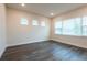 A bright living room with large windows offering natural light, creating a welcoming space for Gathering and friends at 8749 Drummer Plank Dr, Wesley Chapel, FL 33545
