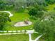 This aerial shot features a playground with slides, swings, and jungle gym equipment in the middle of a park at 8749 Drummer Plank Dr, Wesley Chapel, FL 33545