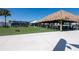 Outdoor recreational area with bar area, tables, seating, and cornhole game at 8749 Drummer Plank Dr, Wesley Chapel, FL 33545