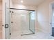 A large glass enclosed walk in shower with white marble and black hardware adds luxury at 8749 Drummer Plank Dr, Wesley Chapel, FL 33545