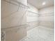 Bright walk-in closet features ample wire shelving for optimal organization and storage at 8749 Drummer Plank Dr, Wesley Chapel, FL 33545