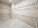 Spacious walk-in closet with wire shelving and marble flooring offers ample storage space at 8749 Drummer Plank Dr, Wesley Chapel, FL 33545