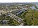 An aerial view of a residential community with waterfront, pools, and lush green trees at 9660 Tara Cay Ct # 38, Seminole, FL 33776