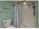 Shower with black shower head, alongside a toilet and towel rack at 9660 Tara Cay Ct # 38, Seminole, FL 33776