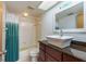 Bathroom featuring a tiled shower and bathtub, complete with a stylish vanity at 9660 Tara Cay Ct # 38, Seminole, FL 33776