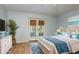 Inviting bedroom featuring stylish decor, wood floors, and French doors at 9660 Tara Cay Ct # 38, Seminole, FL 33776