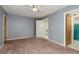 Bedroom with a ceiling fan, neutral walls, and carpet flooring at 9660 Tara Cay Ct # 38, Seminole, FL 33776
