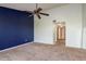 Bedroom with dark blue accent wall, neutral carpet, and connected hallway is spacious and bright at 9660 Tara Cay Ct # 38, Seminole, FL 33776