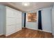 Bright bedroom with modern wood floors and a large murphy bed, providing versatile living space at 9660 Tara Cay Ct # 38, Seminole, FL 33776