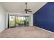 Spacious bedroom with large glass doors and view of lush landscaping at 9660 Tara Cay Ct # 38, Seminole, FL 33776