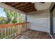 Cozy deck with wooden floors and railing overlooks lush greenery for a relaxing outdoor retreat at 9660 Tara Cay Ct # 38, Seminole, FL 33776