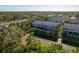 An aerial view of a multi-Gathering residential complex with a pond at 9660 Tara Cay Ct # 38, Seminole, FL 33776