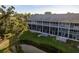 Exterior view of condo building with balconies overlooking a lake at 9660 Tara Cay Ct # 38, Seminole, FL 33776