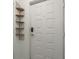 Entryway featuring a white paneled door and decorative wooden shelves at 9660 Tara Cay Ct # 38, Seminole, FL 33776