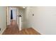 Hallway with wood floors leading to rooms, offering a seamless transition between living spaces at 9660 Tara Cay Ct # 38, Seminole, FL 33776