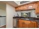 The kitchen is equipped with stainless steel appliances, granite countertops, and wood cabinets at 9660 Tara Cay Ct # 38, Seminole, FL 33776