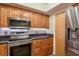 Kitchen featuring stainless steel appliances, updated cabinets, and stone countertops at 9660 Tara Cay Ct # 38, Seminole, FL 33776