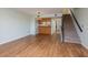 Open floor plan to the kitchen and living room with hardwood floors and a staircase at 9660 Tara Cay Ct # 38, Seminole, FL 33776