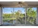 Screened patio view of lush green landscaping, and community pond at 9660 Tara Cay Ct # 38, Seminole, FL 33776
