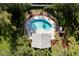 An aerial view of a community pool with lounge chairs and a covered pavilion at 9660 Tara Cay Ct # 38, Seminole, FL 33776
