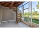 Enclosed porch with a spiral staircase offering serene views of the backyard pond at 9660 Tara Cay Ct # 38, Seminole, FL 33776