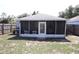 Backyard view of enclosed patio with grill and fenced yard at 1006 Harvest Moon Dr, Seffner, FL 33584
