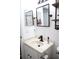 Well-lit bathroom with two mirrors, a floating industrial shelf, and a white vanity at 1006 Harvest Moon Dr, Seffner, FL 33584