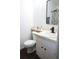 Bright bathroom featuring a white single sink vanity, black fixtures, and a floral shower curtain at 1006 Harvest Moon Dr, Seffner, FL 33584
