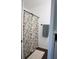 The bathroom features tile floors, a floral shower curtain, and a soft rug at 1006 Harvest Moon Dr, Seffner, FL 33584