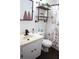 Bathroom featuring a floral shower curtain, dark plank flooring, and industrial style shelving at 1006 Harvest Moon Dr, Seffner, FL 33584